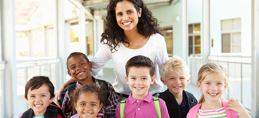 Teacher with group of students outside.